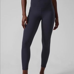 ATHLETA Salutation 7/8 Tights with Stash Pocket. Navy blue medium.